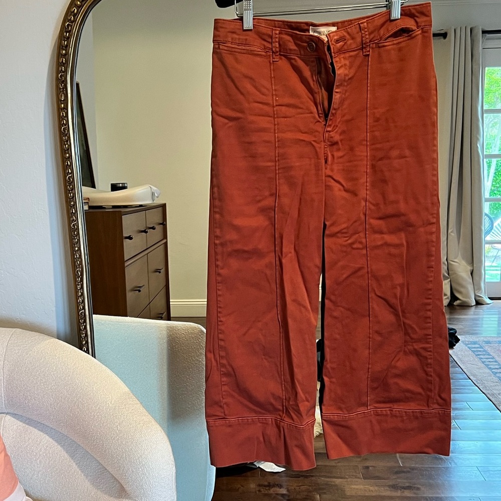 Anthropologie orange flare pants